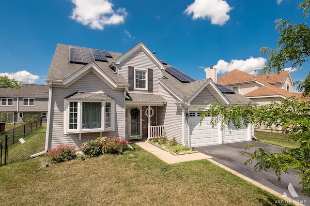 40 Jackson Ln, Streamwood, IL 60107 - traditional home with a shingled roof, driveway, and solar panels