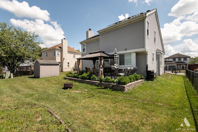 40 Jackson Ln, Streamwood, IL 60107 - rear view of house featuring a gazebo, a storage shed, a chimney, and a fire pit