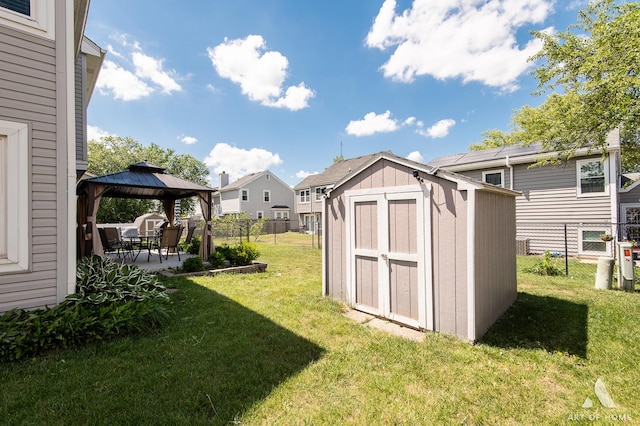 40 Jackson Ln, Streamwood, IL 60107 - fenced backyard with a gazebo, a shed, a patio area, and a residential view