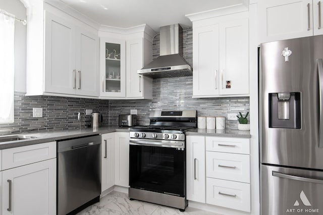 40 Jackson Ln, Streamwood, IL 60107 - kitchen featuring stainless steel appliances, wall chimney exhaust hood, light marble finish floors, white cabinetry, and glass insert cabinets