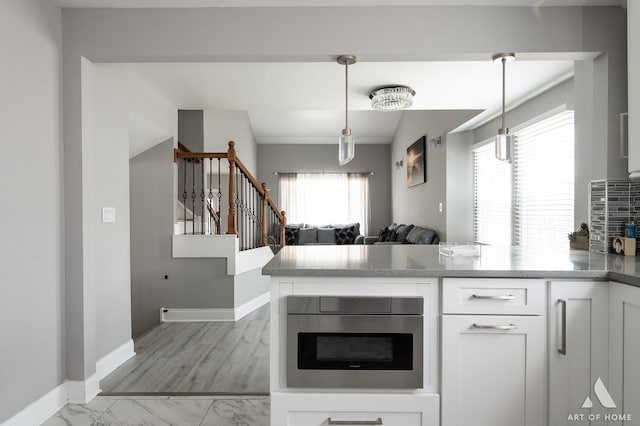 40 Jackson Ln, Streamwood, IL 60107 - kitchen featuring a peninsula, plenty of natural light, and white cabinetry
