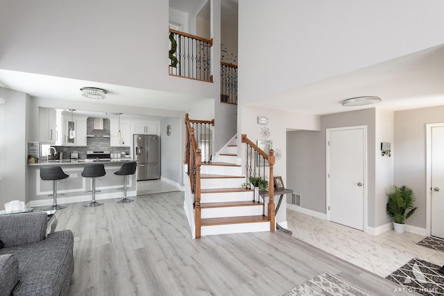 40 Jackson Ln, Streamwood, IL 60107 - entryway featuring stairway, a high ceiling, and light wood-style floors