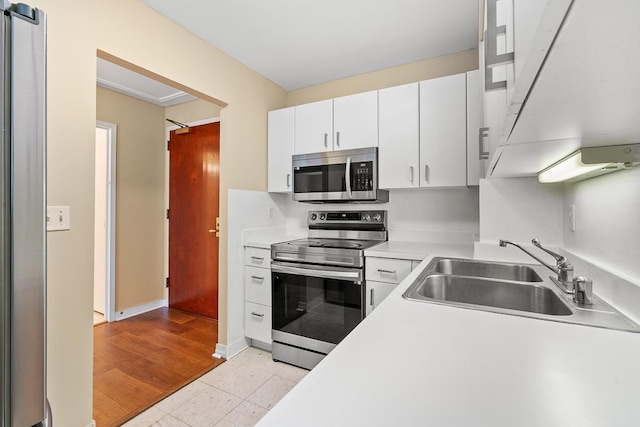 401 E Ontario St Unit 2804, Chicago, IL 60611 - kitchen with appliances with stainless steel finishes, light countertops, white cabinetry, and light tile patterned floors