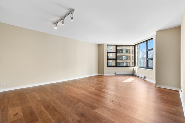 401 E Ontario St Unit 2804, Chicago, IL 60611 - spare room with wood finished floors and rail lighting