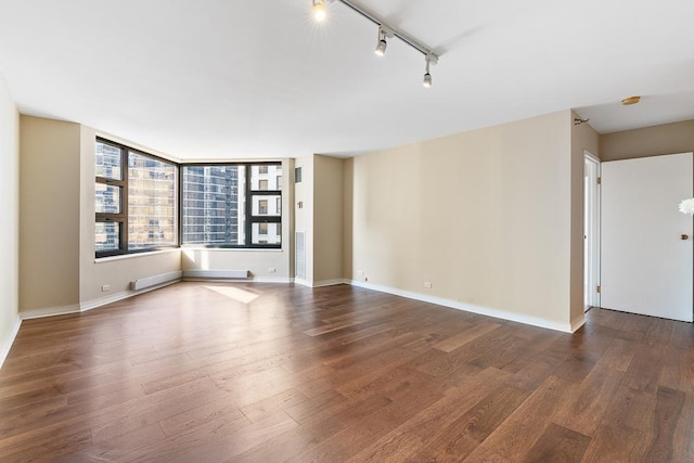 401 E Ontario St Unit 2804, Chicago, IL 60611 - unfurnished room featuring dark wood-style floors, rail lighting, and a smoke detector