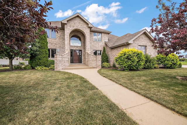 1920 Summerfield Ln, Bourbonnais, IL 60914 - traditional home with brick siding, a front yard, and roof with shingles
