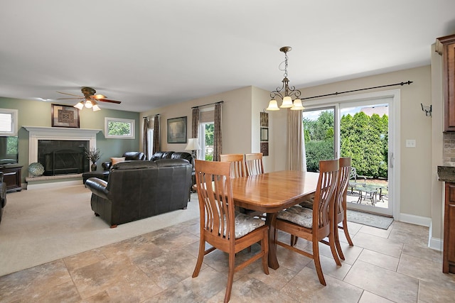 1920 Summerfield Ln, Bourbonnais, IL 60914 - dining room with a ceiling fan, healthy amount of natural light, a chandelier, and a tiled fireplace