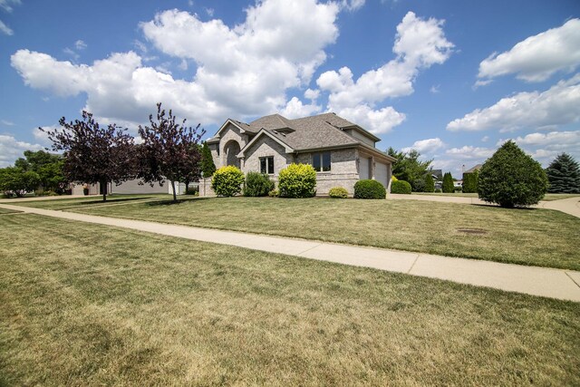 1920 Summerfield Ln, Bourbonnais, IL 60914 - traditional-style home with an attached garage, a front yard, brick siding, driveway, and roof with shingles