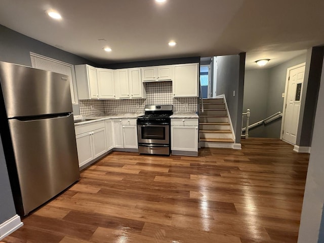 8809 S Harvard Ave, Chicago, IL 60620 - kitchen with stainless steel appliances, white cabinets, light countertops, decorative backsplash, and wood finished floors