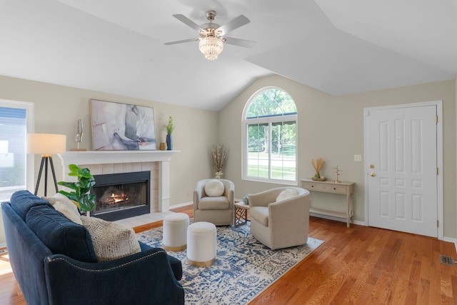 231 E Fullerton Ave, Glendale Heights, IL 60139 - living room featuring ceiling fan, light wood-style flooring, a tiled fireplace, and vaulted ceiling