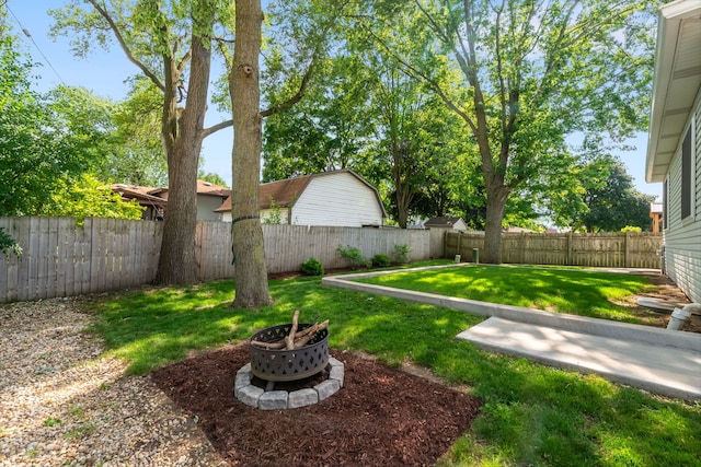 231 E Fullerton Ave, Glendale Heights, IL 60139 - fenced backyard featuring a fire pit
