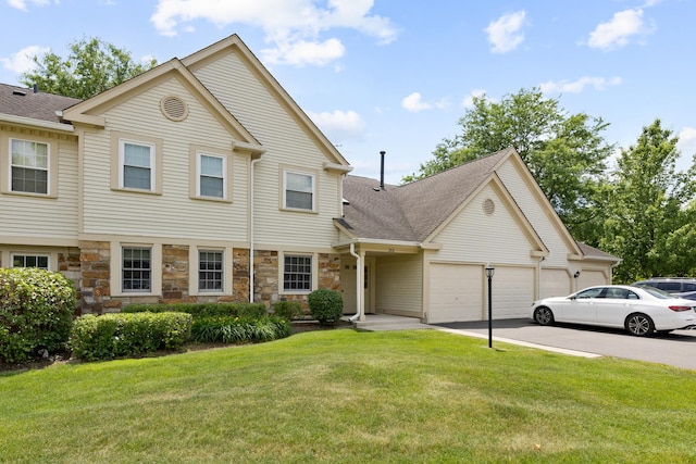 202 Dublin Ln Unit V-1, Schaumburg, IL 60194 - view of front of house featuring an attached garage, a front lawn, stone siding, driveway, and roof with shingles