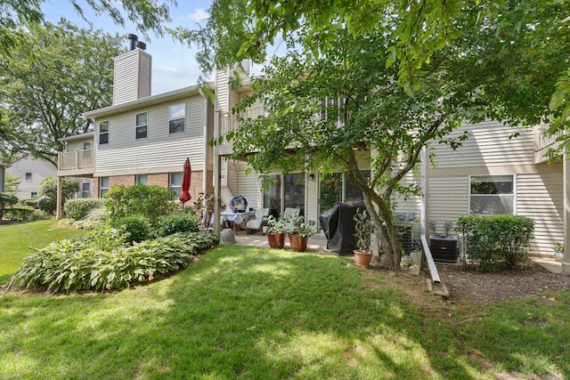 202 Dublin Ln Unit V-1, Schaumburg, IL 60194 - rear view of property with a yard, a chimney, and a balcony