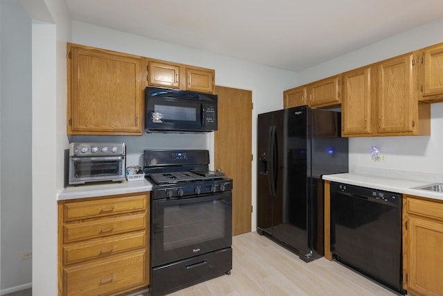 202 Dublin Ln Unit V-1, Schaumburg, IL 60194 - kitchen featuring black appliances, light countertops, and light wood finished floors