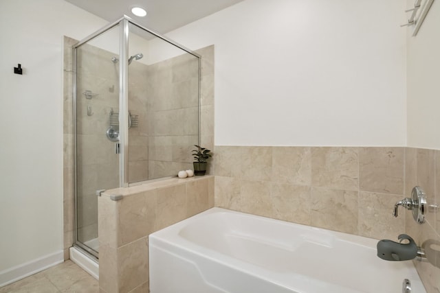 3125 W Fullerton Ave Unit 508, Chicago, IL 60647 - full bathroom featuring a bath, a stall shower, and tile patterned flooring