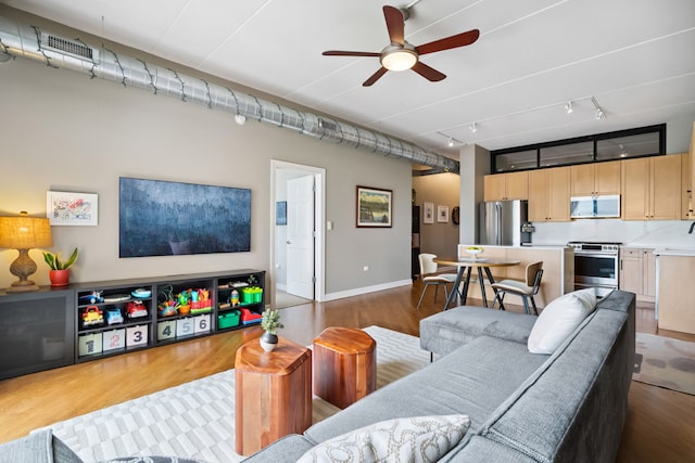 3125 W Fullerton Ave Unit 508, Chicago, IL 60647 - living area with rail lighting, wood finished floors, and ceiling fan
