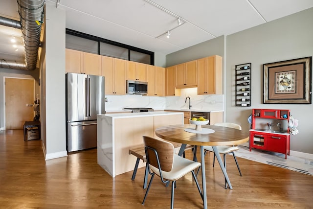 3125 W Fullerton Ave Unit 508, Chicago, IL 60647 - kitchen with stainless steel appliances, light brown cabinets, wood finished floors, light countertops, and a kitchen island