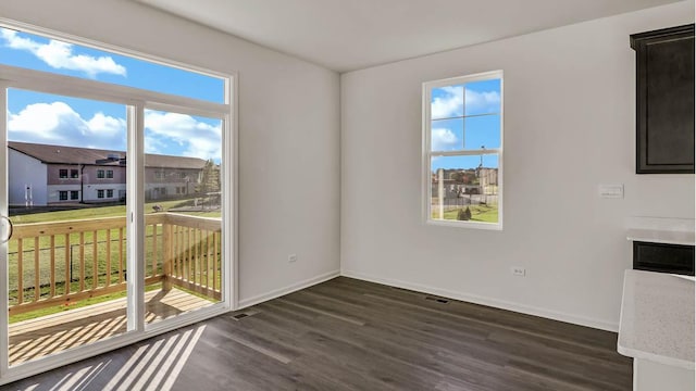 11371 Wildridge Ln, Huntley, IL 60142 - unfurnished dining area featuring dark wood-type flooring and a residential view