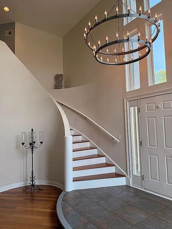 06N274 W Ridgewood Ln, Saint Charles, IL 60175 - foyer entrance featuring a chandelier, a high ceiling, stairs, wood finished floors, and recessed lighting