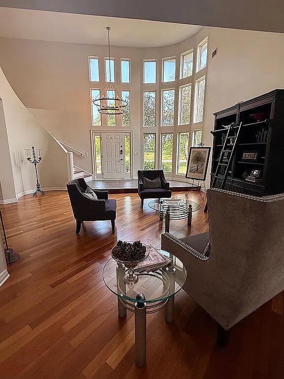 06N274 W Ridgewood Ln, Saint Charles, IL 60175 - living room featuring hardwood / wood-style floors, stairway, and a high ceiling