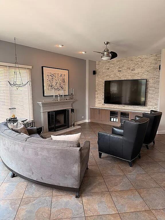 06N274 W Ridgewood Ln, Saint Charles, IL 60175 - tiled living area featuring a fireplace with raised hearth and ceiling fan