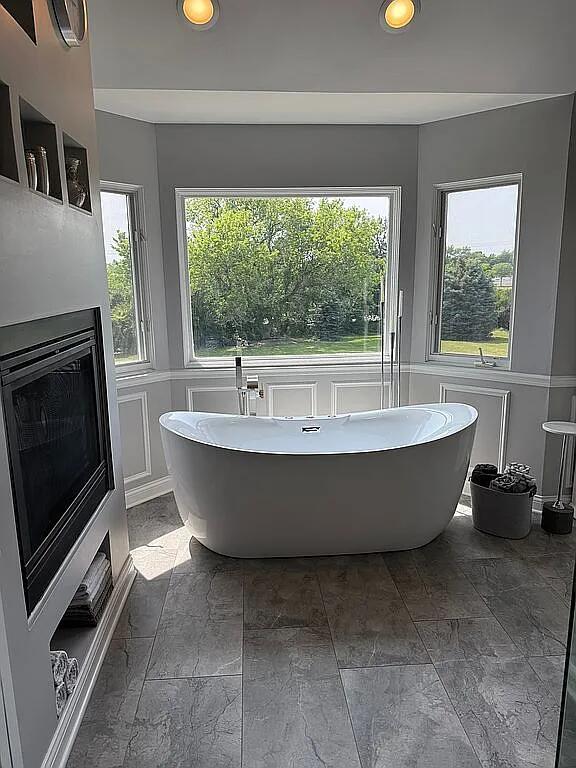 06N274 W Ridgewood Ln, Saint Charles, IL 60175 - full bath with a freestanding tub, recessed lighting, a decorative wall, a fireplace, and stone tile flooring