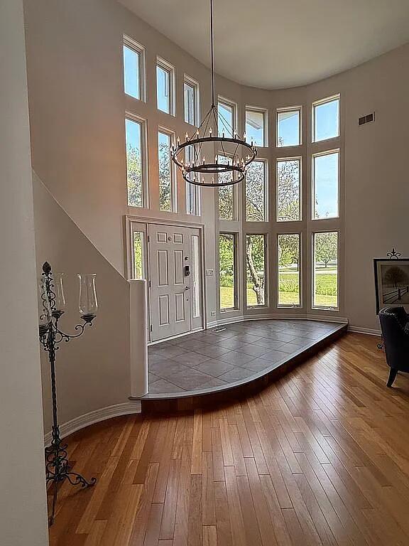 06N274 W Ridgewood Ln, Saint Charles, IL 60175 - foyer with a high ceiling, hardwood / wood-style flooring, and a chandelier