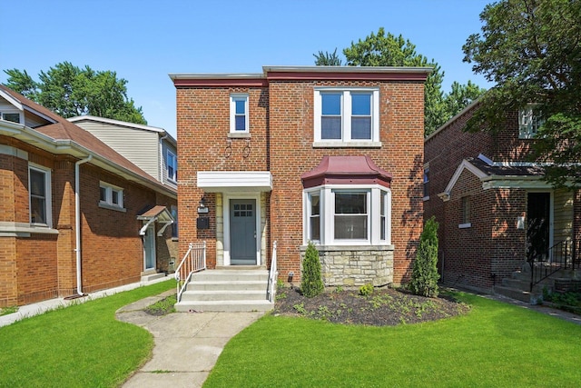 8051 S Paxton Ave, Chicago, IL 60617 - view of front of home with a front lawn, stone siding, and brick siding