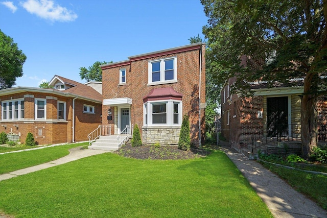 8051 S Paxton Ave, Chicago, IL 60617 - view of property with a front yard and brick siding