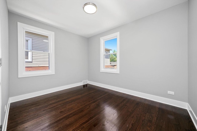 8051 S Paxton Ave, Chicago, IL 60617 - empty room featuring baseboards and dark wood-type flooring