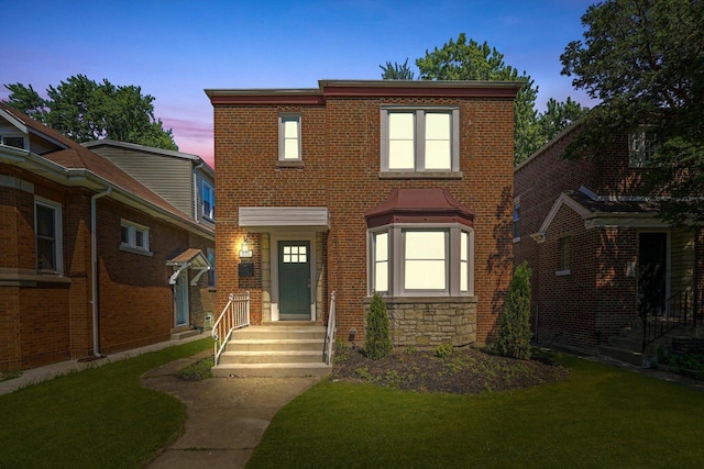 8051 S Paxton Ave, Chicago, IL 60617 - view of front of home featuring a lawn, stone siding, and brick siding