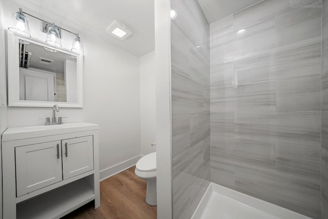 8051 S Paxton Ave, Chicago, IL 60617 - bathroom featuring vanity, wood finished floors, and a tile shower
