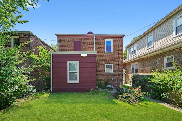 8051 S Paxton Ave, Chicago, IL 60617 - back of house with a lawn and brick siding
