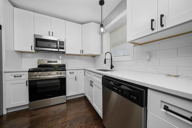 8051 S Paxton Ave, Chicago, IL 60617 - kitchen featuring appliances with stainless steel finishes, white cabinetry, and tasteful backsplash