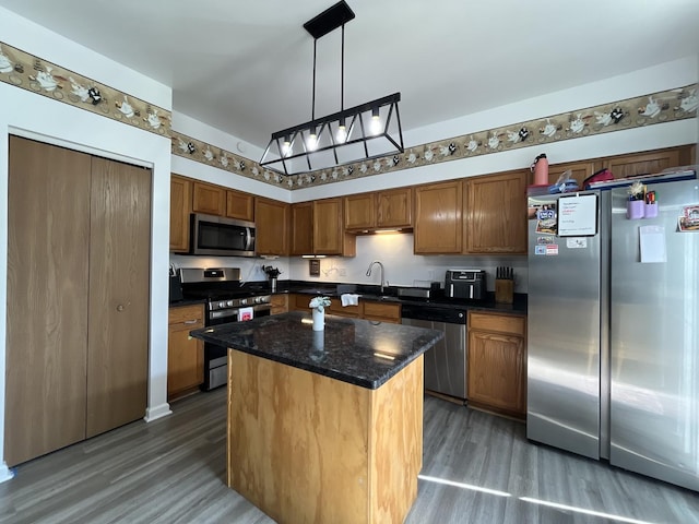 14143 S Napa Cir, Plainfield, IL 60544 - kitchen featuring stainless steel appliances, wood finished floors, a kitchen island, and decorative light fixtures
