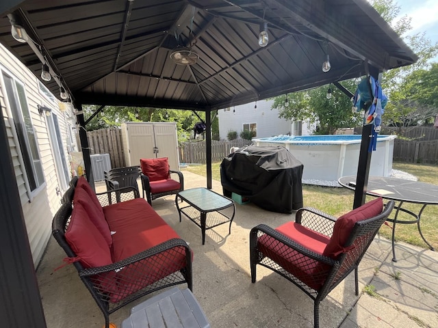 14143 S Napa Cir, Plainfield, IL 60544 - fenced backyard featuring a grill, an outdoor hangout area, a gazebo, a shed, and a patio