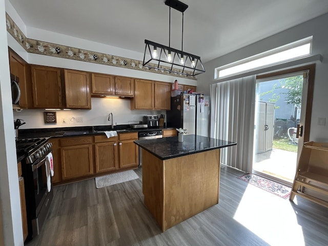 14143 S Napa Cir, Plainfield, IL 60544 - kitchen with stainless steel appliances, dark wood-style floors, a center island, brown cabinetry, and dark stone counters