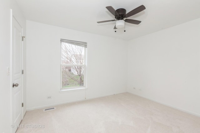 1110 Oakhill Dr, Aurora, IL 60502 - spare room featuring light carpet and a ceiling fan