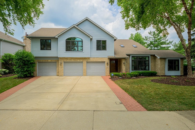 10732 Revere Rd, Mokena, IL 60448 - traditional-style house with a front yard, concrete driveway, a garage, brick siding, and a shingled roof