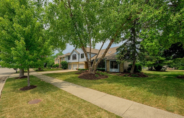 10732 Revere Rd, Mokena, IL 60448 - view of front facade with an attached garage, brick siding, a front yard, and driveway