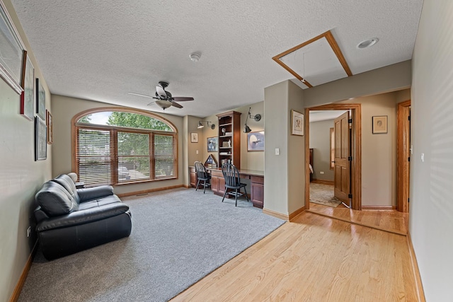 10732 Revere Rd, Mokena, IL 60448 - living area with attic access, light wood finished floors, ceiling fan, a textured ceiling, and built in study area