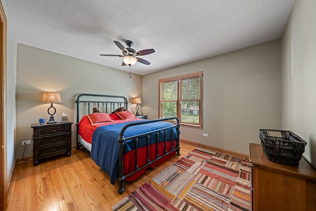 10732 Revere Rd, Mokena, IL 60448 - bedroom featuring light wood-type flooring, a textured ceiling, and ceiling fan