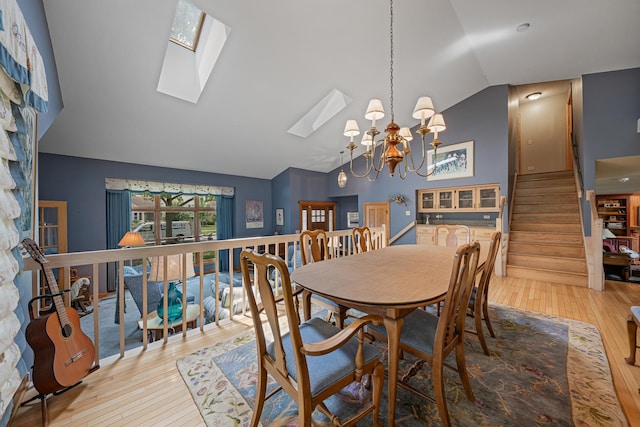 10732 Revere Rd, Mokena, IL 60448 - dining room with vaulted ceiling, hardwood / wood-style floors, a skylight, a chandelier, and stairs