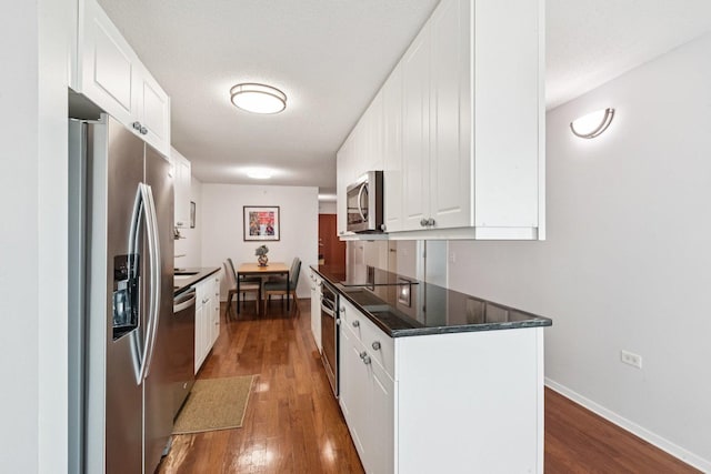 800 Elgin Rd Unit 1017, Evanston, IL 60201 - kitchen featuring appliances with stainless steel finishes, dark wood finished floors, and white cabinetry