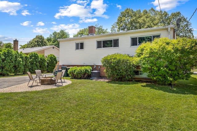 817 N Gibbons Ave, Arlington Heights, IL 60004 - back of house featuring a fire pit, a lawn, a chimney, and a patio area