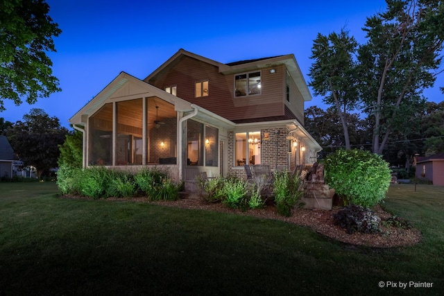 1913 N Woodlawn Park Ave, Mchenry, IL 60051 - view of front facade featuring ceiling fan, a front yard, a porch, and a sunroom