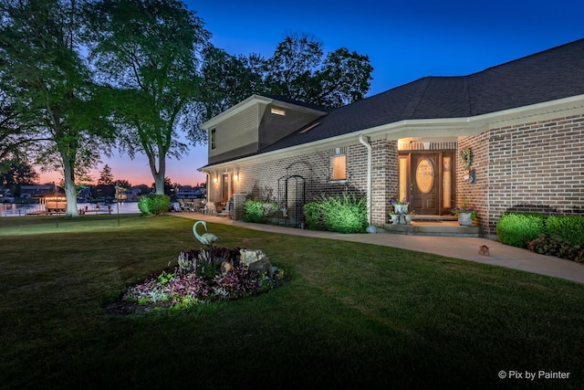 1913 N Woodlawn Park Ave, Mchenry, IL 60051 - view of front of home with brick siding, a lawn, and roof with shingles