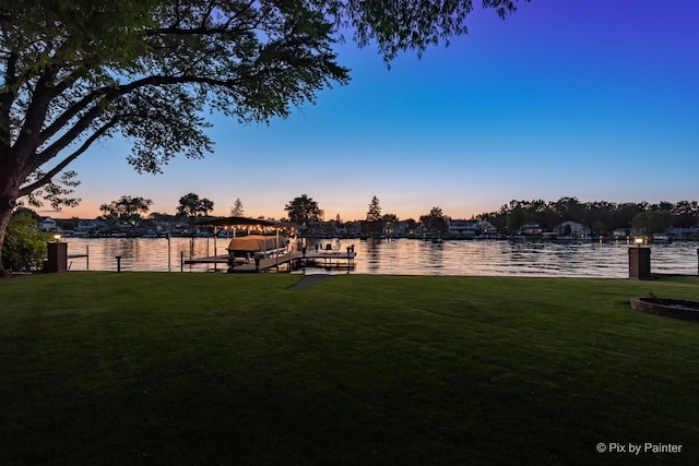 1913 N Woodlawn Park Ave, Mchenry, IL 60051 - yard at dusk featuring a dock, a lawn, and a water view