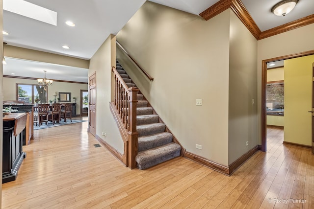 1913 N Woodlawn Park Ave, Mchenry, IL 60051 - staircase featuring ornamental molding, a chandelier, hardwood / wood-style floors, recessed lighting, and a skylight