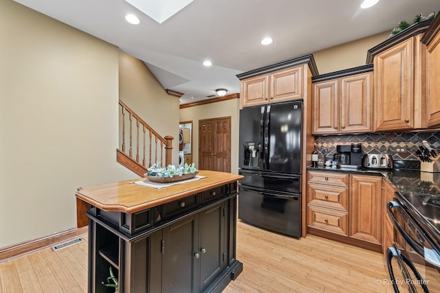 1913 N Woodlawn Park Ave, Mchenry, IL 60051 - kitchen with black appliances, tasteful backsplash, light wood-style floors, ornamental molding, and a kitchen island